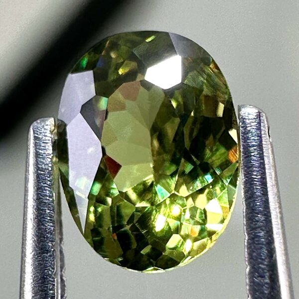 0.46 carat natural demantoid garnet from Namibia, bright green color, eye-clean clarity, and exceptional brilliance.