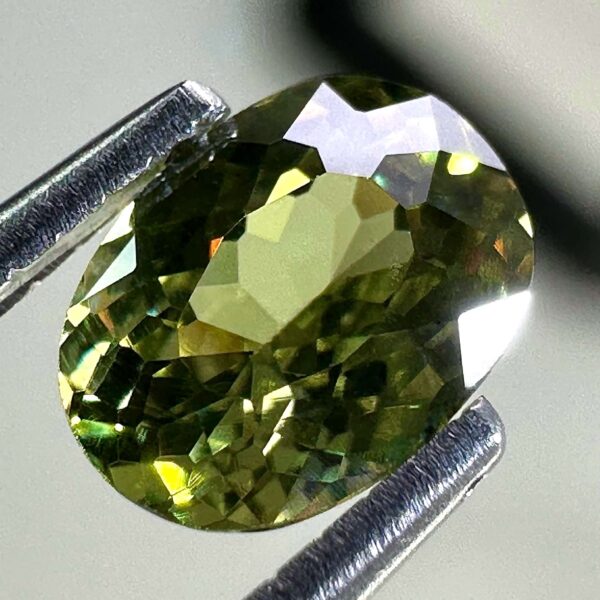 0.46 carat natural demantoid garnet from Namibia, bright green color, eye-clean clarity, and exceptional brilliance.