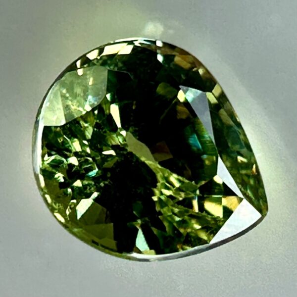 0.43 carat natural demantoid garnet from Namibia, bright green color, and excellent clarity.