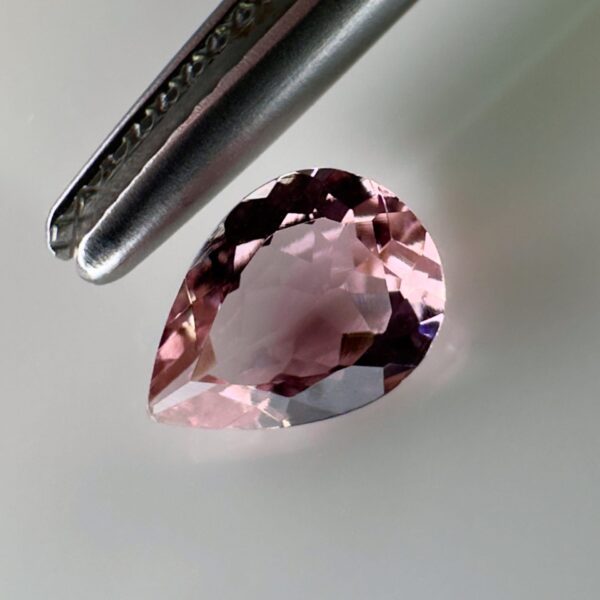 Pink tourmaline gemstone, 0.58 carat, pear-shaped cut, rare salmon pink color, beautiful clarity, and brilliant shine.